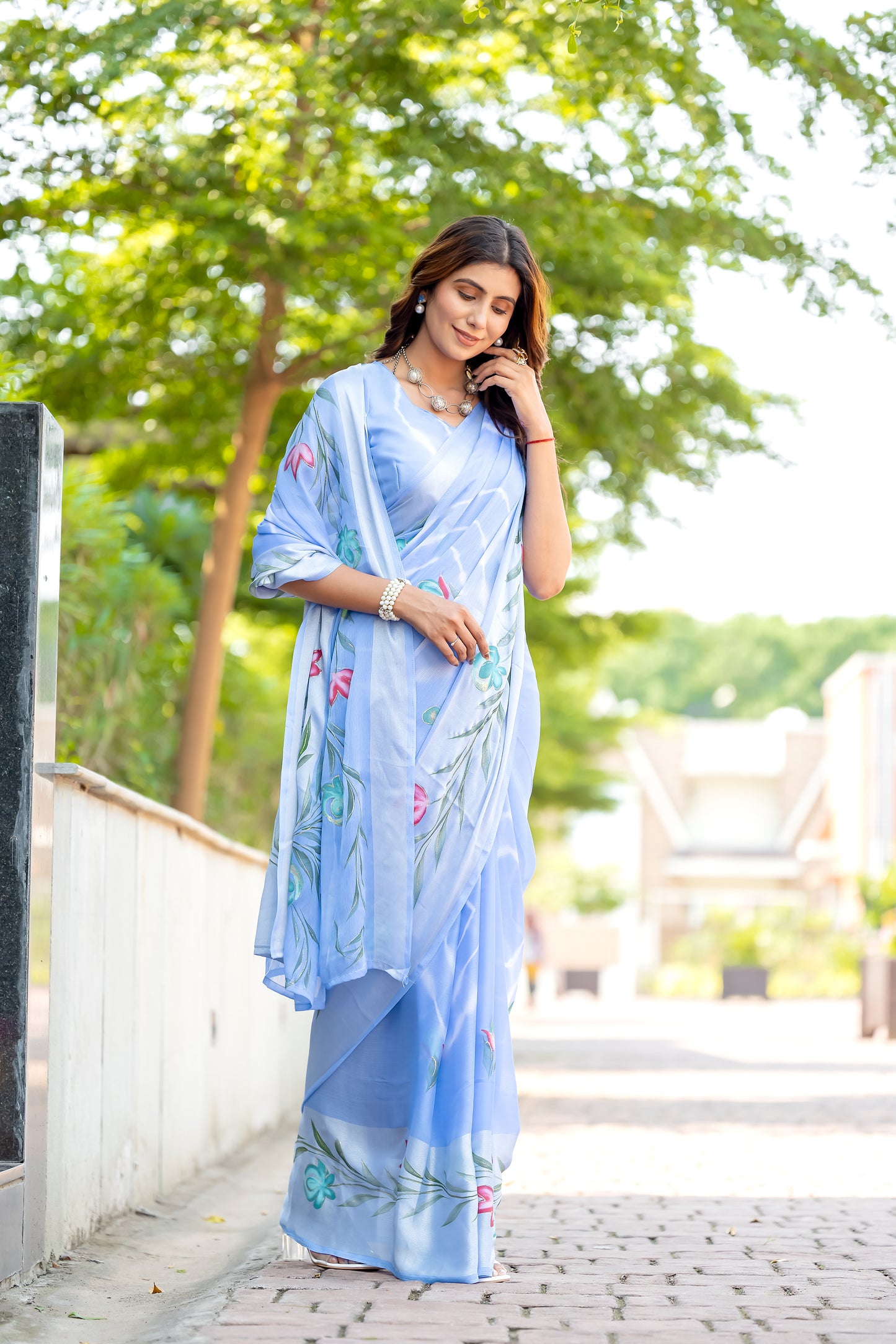 Chiffon Sky Blue Saree Featuring Delicate Hand Painted Floral Motifs
